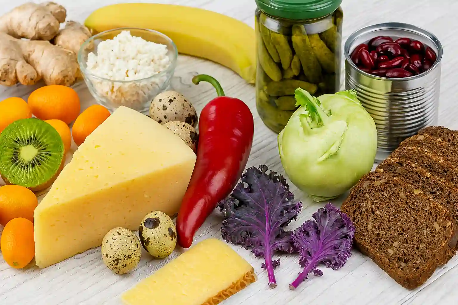 Flat lay of 20 colorful foods that start with the letter K, including kiwi, kebabs, kimchi, and korma.