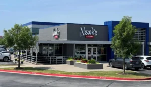 Exterior view of Newk's Eatery restaurant with modern building design and outdoor seating.