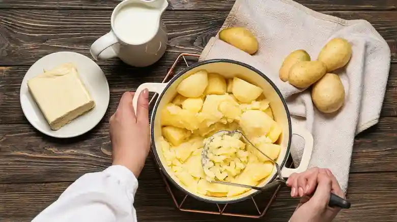 Soft Foods for Braces: Easy Recipes to Make at Home | Braces-Friendly Meal Guide 2 A landscape image showcasing various potato-based dishes suitable for people with braces, including creamy mashed potatoes, cheesy potato bake, and soft boiled potatoes arranged on a rustic wooden table with warm lighting.